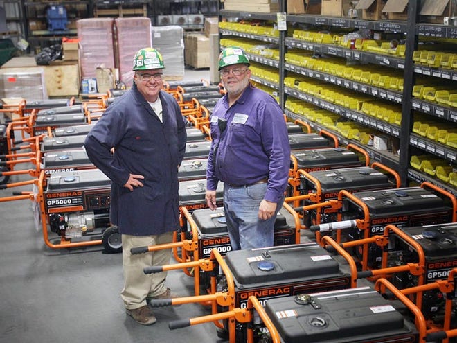 Randy Skagen, vice president and general manager of Nucor Steel in Tuscaloosa, and warehouse supervisor David Nevin, right, stand among some of the 72 Generac 5,000-watt generators that Nucor is donating to people affected by the deadly tornado that hit Joplin, Mo. on Sunday.