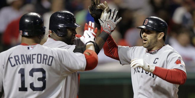 Boston catcher Jason Varitek is greeted by David Ortiz and Carl Crawford (13) after Varitek's two-run homer in the seventh inning of Tuesday night's game.