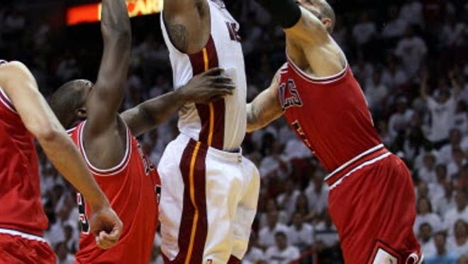 Heat forward Chris Bosh is fouled on a dunk attempt in overtime Tuesday in Miami. (Allen Eyestone/The Palm Beach Post)