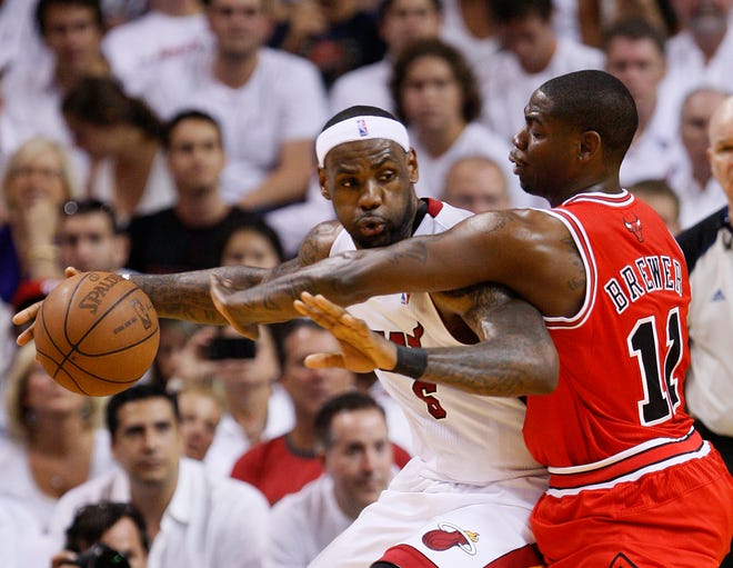 Miami's LeBron James, left, drives up against Chicago's Ronnie Brewer during Game 4 of the NBA Eastern Conference Finals. The Heat outlasted the Bulls 101-93 in overtime to take a 3-1 lead in the best-of-seven series. James had 35 points and six assists in the game. Chicago's Derrick Rose had 23 to lead the Bulls.