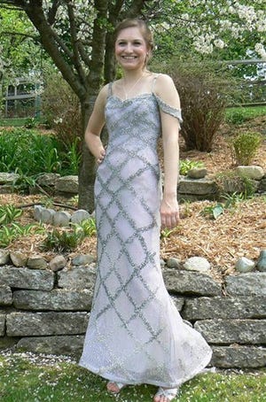 This May 13, 2011 family photo shows Kayla Staskiewicz dressed for the Waterford Mott High School prom in actress Christina Ricci's Oscars dress, a $25,000 design from Versace Couture, at her home in Waterford, Mich. Staskiewicz won a WDIV-TV contest for a chance to wear the dress to the prom but then had to fit into the size 0 design, which turned out to fit. (AP Photo/Family photo via The Oakland Press)