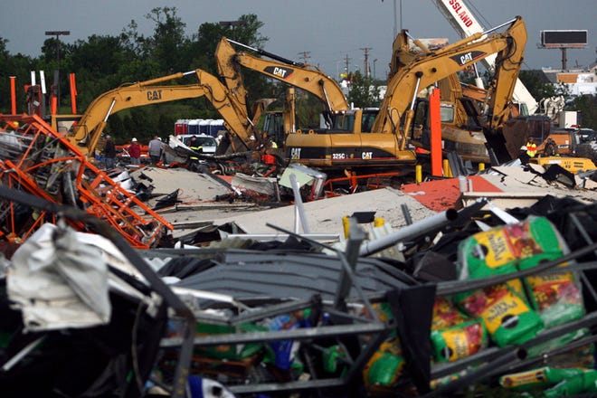 Bulldozers sift through the rubble of a collapsed Home Depot store in Joplin, Mo., Monday, May 23, 2011. A destructive tornado swept through Joplin on Sunday evening, killing at least 116 and injuring hundreds more.