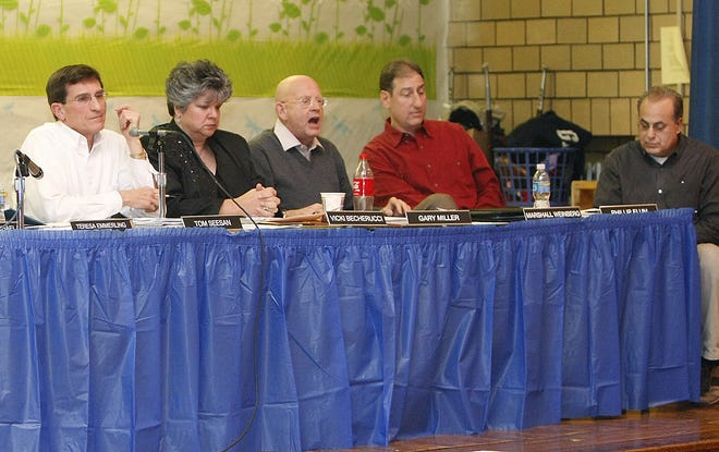 Massillon Board of Education members Tom Seesan, Vicki Becherucci, Gary Miller, Marshall Weinberg and Phil Elum field questions as they meet with the public at Emerson Elementary School last year.