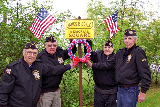 Members of DAV Billerica Chapter 47 are seen adorning a veteran's square in Billerica with a memorial wreath and American flags donated by the town. Left to right are Roland Durrell, Larry Christianson, Ken Sennett and Vinney Freeman.