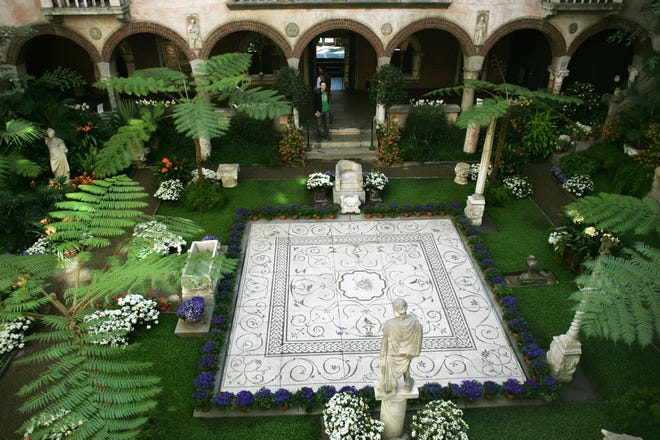 A lush green garden features a Roman mosaic floor in the middle of the courtyard with an image of Medusa in the middle. Daily News Photo By Jacob Belcher