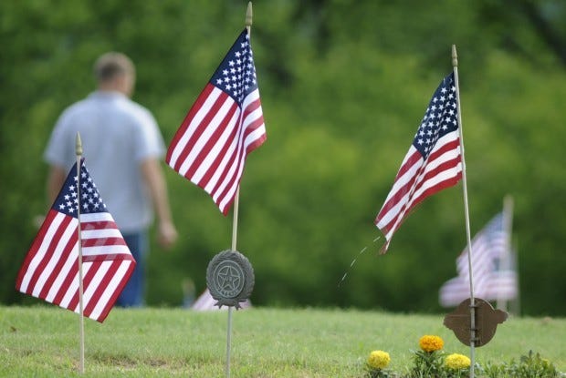 American flags wave in the breeze over the graves of veterans at Grandview Cemetery in Big Beaver Thursday morning, in preparation for Memorial Day.