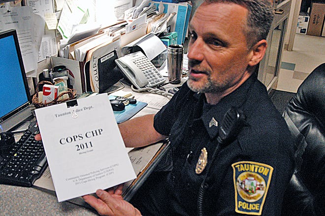 Sgt. Kevin Medas holds a copy of the COPS CHP federal grant program by which he hopes to attain funding to hire five additional Taunton cops.
