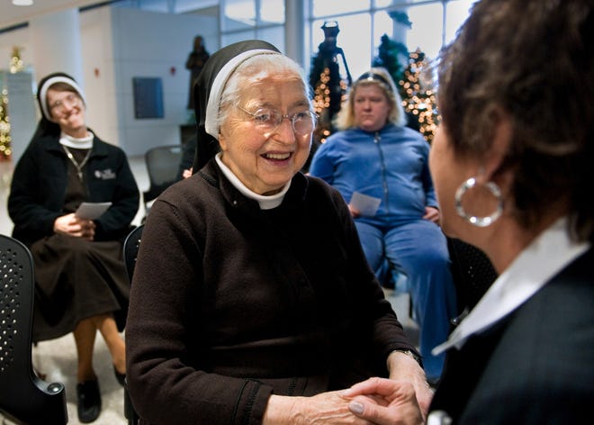 Cookie Bannon, right, visits with Sister M. Canisia Gerlach, 96, who worked as administrator for OSF Saint Francis Medical Center for 38 years, in December 2010. A commemorative statue in her honor is in the lobby of the Children’s Hospital of Illinois. Sister Canisia died Thursday.
