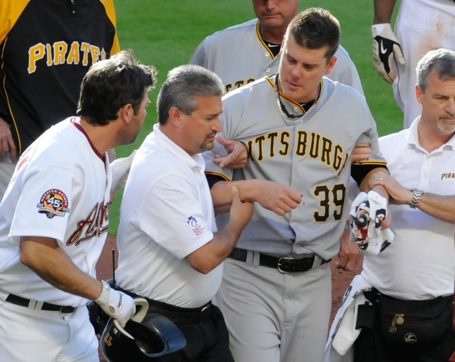 MAJOR LEAGUE BASEBALL: Pittsburgh Pirates' starting pitcher Chris Jakubauskas (39) is helped off the field after taking a line drive to the head from Houston Astros' Lance Berkman, left, in the first inning of a baseball game Saturday, April 24, 2010, in Houston. (AP Photo/Pat Sullivan) ORG XMIT: HTA103