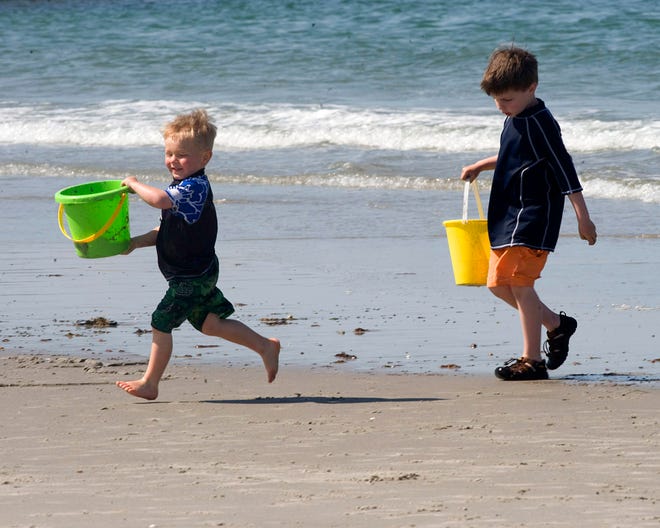 Adam Bushley of Cohasset and his big brother Charlie play on Sandy Beach together.