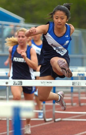 Swampscott girls spring track sophomore Vy Le clears one of the last hurdles on her way to a first-place finish in the 100-meter hurdles against Peabody May 24.