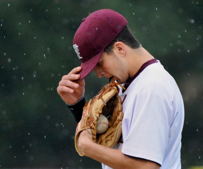 IVC pitcher Braden McIntyre bites his glove and concentrates on the mound as rain begins to fall in the 13th inning of Friday's Class 2A Chillicothe sectional semifinal. IVC lost to Rock Ridge, 4-0.