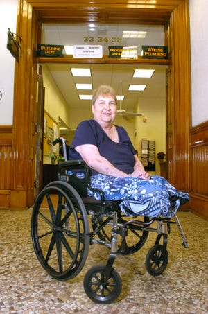 Jeri Celia, a clerk in the Brockton Building Department, is back to work at her office in City Hall.