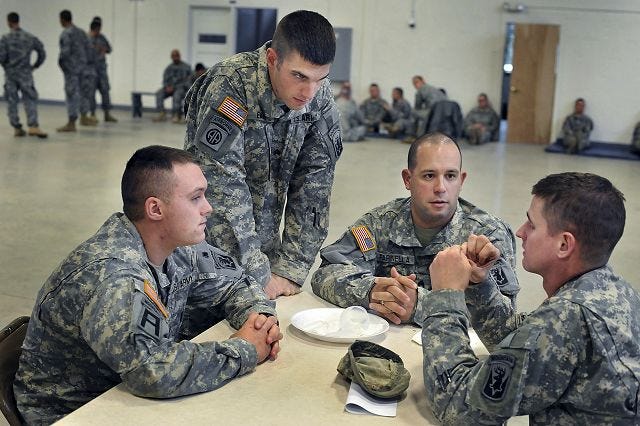 File photo
National Guard members relax at the National Guard armory in Brewer, Maine in 2009. The guard unit was set to leave for Afghanistan later that day.