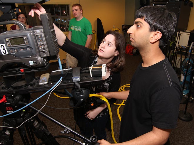 (05/27/11 HOPKINTON, MA) 
Stephanie Kane, left, a news producer at HCAM-TV in Hopkinton, shows volunteer Nimish Ajmani, 18, right, new camera settings as the crew gears up to record the station's newscast on Friday afternoon.