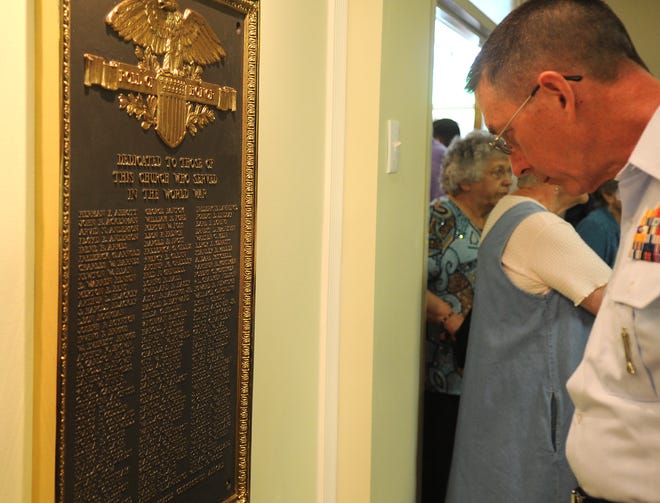 Lt. Colonel Charles Neudorfer of Brockton looks at one of the plaques.