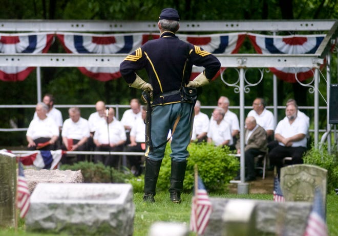 Regimental Sgt. major Alan Kilgore stands as he listens to the Memorial Day service held Sunday afternoon at Soldiers Hill in Springdale Cemetery. Kilgore, who is originally from Peoria but now resides in Chestnut, is part of the 10th Illinois Cavalry, a group of 75 members who reenact the Civil War.