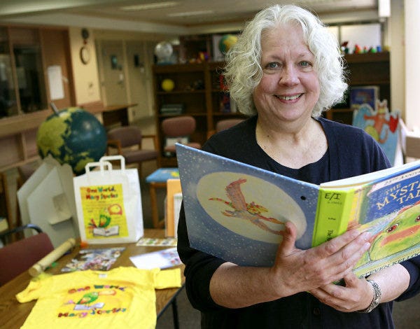 Librarian Sammie Willis poses with a twin vision book at the Oklahoma Library for the Blind and Physically Disabled. A twin vision book provides the braille version of a story on a clear sheet that overlays the regular pages. The library will start its summer reading program this week. JOHN CLANTON - THE OKLAHOMAN