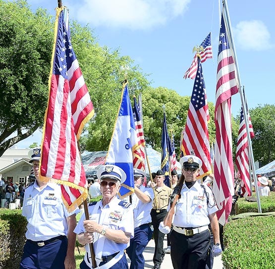 Participants in the annual Memorial Day Ceremony held at the St. Augustine National Cemetery retire the colors at the end of the presentation on Monday. Photos by PETER WILLOTT, peter.willott@staugustine.com