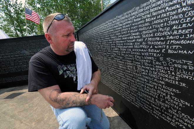 Russell Currier pauses at the Moving Wall as he looks at the name of his son, US Marine Eric Currier, who was killed last year in Afghanistan.
