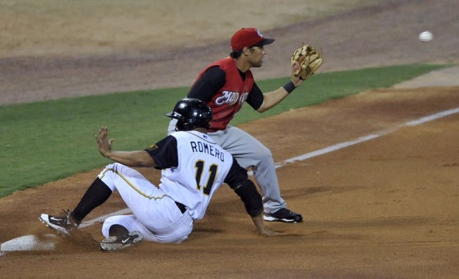 The Suns' Alex Romero (11) slides into third base as Mudcats third baseman Jake Kahaulelio waits for the throw on a triple at the Baseball Grounds of Jacksonville on Tuesday night.