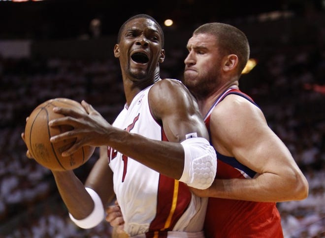 Chris Bosh, seen backing in the Sixers' Spencer Hawes during the
NBA playoffs last spring, and the Miami Heat are the team to beat
this season.