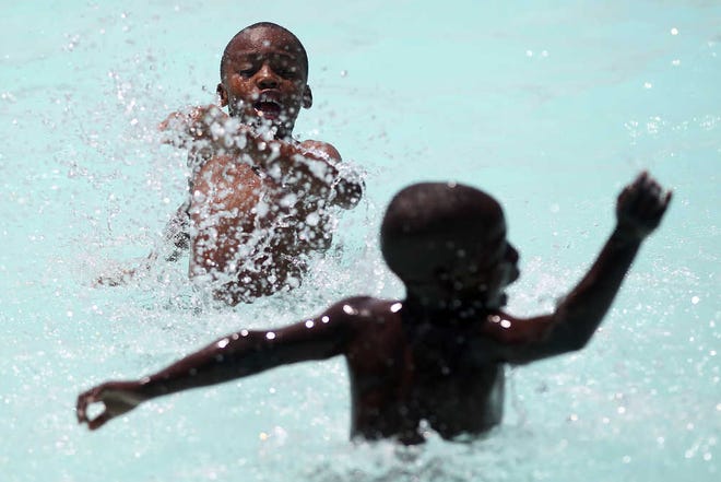 Zae Traylor, 9, splashes Travis Mitchell, 6, at Mae Simmons Pool in Lubbock, Texas, Tuesday, May 31, 2011. (Miranda Grubbs/ Lubbock Avalanche-Journal)