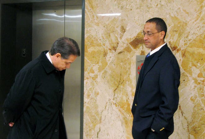 In this Feb, 7 file photo, John Paul Hernandez, right, and his attorney, Albert G. Valadez, wait for an elevator at the Lubbock County Courthouse during jury selection in Hernandez's trial. The attorney for a former West Texas youth prison inmate said Tuesday his client has settled a civil lawsuit against the former prison school principal who was found not guilty of sexually abusing five inmates at the West Texas State School in Pyote in 2004 and 2005.