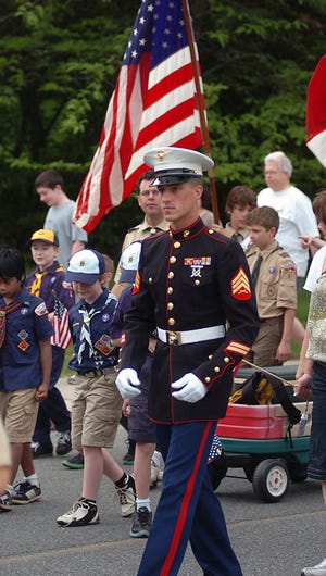 Sgt. Jason Watkins marches along with Hopedale Scouts in yesterday's Memorial Day parade in Hopedale.
