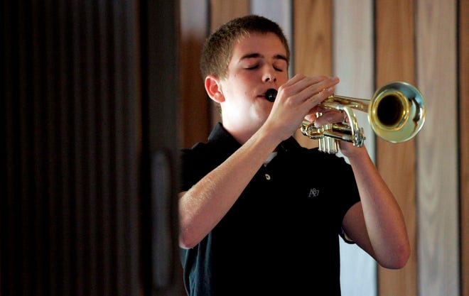 Colton McCray, 16, plays taps Sunday, May 29, 2011, during a memorial service at the Burritt Community Church in Wempletown.