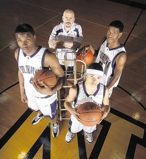 An investigation was launched after former Newburgh Free Academy players said boys’ basketball coach Frank Dinnocenzio and administrators allowed them to play despite cutting more than 1,000 classes. Dinnocenzio, rear, stands with players, from left, Michael McLeod, Marcus Henderson and Damon Cousar in 2009.