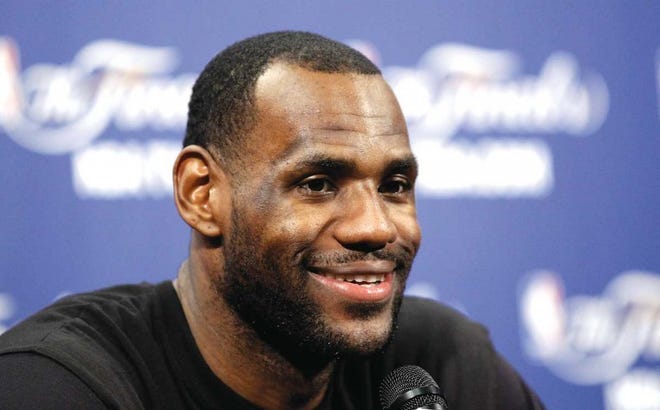 Miami Heat's LeBron James smiles as he answers a question Monday in Miami. The Dallas Mavericks will play the Heat in Game 1 of the NBA finals today.