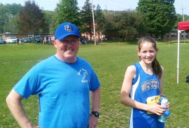 Coach Dave Swanson and Olivia Cannon, who finished fourth in the 2-mile and qualified for this weekend’s state meet.