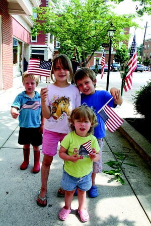 The Hunsberger children had a flag wavin’ time at the Greencastle Memorial Day parade Monday. From left are Cameron, 3, Kirstyn, 6, Cory, 5 and in front, Megan, 2.