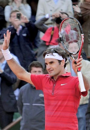 Roger Federer celebrates his victory over Gael Monfils at the French Open Tuesday in Paris. By MICHEL EULER, The Associated Press