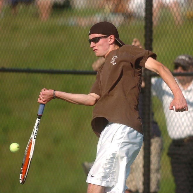 Stonington's Daniel Banker returns the ball to NFA during the ECC boys tennis doubles championship at New London High School Tuesday, May 31, 2011.