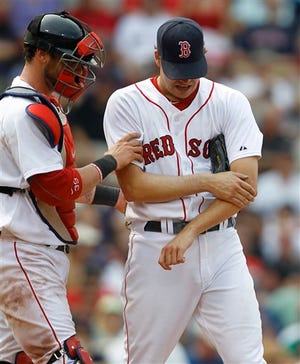 Boston Red Sox pitcher Rich Hill, right, is assisted by Red Sox catcher Jarrod Saltalamacchia as he leaves the game with a forearm injury after facing just one batter in the seventh inning of a baseball game against the Chicago White Sox, Wednesday, June 1, 2011, at Fenway Park, in Boston. The White Sox defeated the Red Sox 7-4.