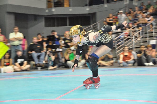 New Jax Rollers skater Michelle "Crash" Register, 26, a nursing assistant by day at the Jacksonville Hearing and Balance Institute on the Southside, competes in the Professional Roller Derby at UNF Arena in April.
