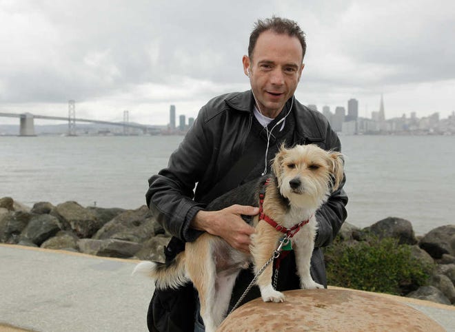 Timothy Ray Brown, the only man ever known to have been apparently cured from AIDS, is shown with his dog, Jack, on Treasure Island in San Francisco. Brown was in a Berlin hospital in 2007, worrying whether leukemia or the AIDS virus would do him in, when his German doctor said he had an "off the wall" idea for tackling both.