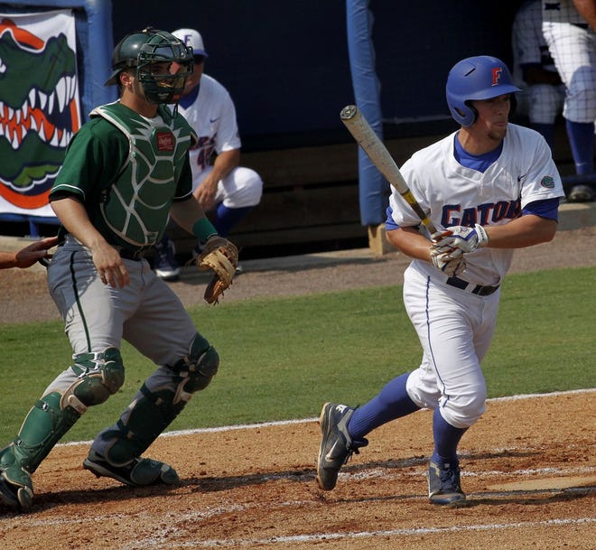 Florida's Nolan Fontana (right) follows through on a hit against Manhattan during the Gainesville Regional on Friday in Gainesville. The Gators won, 17-3.