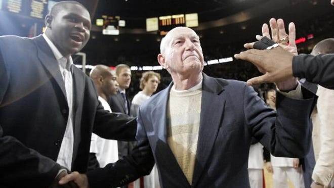 Former Portland Trail Blazers basketball coach Jack Ramsey, right, shakes hands with Blazers forward Zach Randolph and greets other players as he is introduced on court before the Blazers' NBA basketball game against the Golden State Warriors in Portland, Ore., Wednesday, April 18, 2007. Ramsey coached the Blazers to their 1977 NBA championship.(AP Photo/Don Ryan)