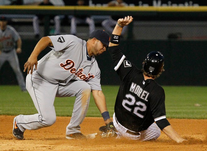 Detroit Tigers shortstop Jhonny Peralta, left, tags out Chicago White Sox's Brent Morel trying to steal second during the fourth inning of a baseball game on Friday, June 3, 2011, in Chicago.