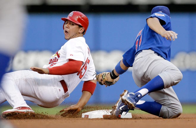 St. Louis Cardinals' Jon Jay, left, is safe at second for a stolen base as Chicago Cubs second baseman Darwin Barney attempts the tag during the third inning of a baseball game Friday, June 3, 2011, in St. Louis.