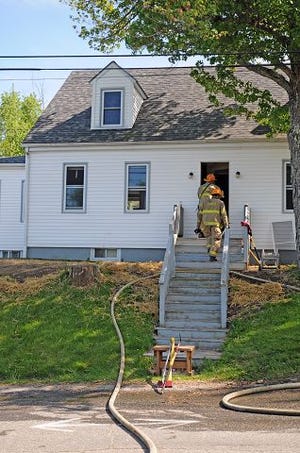 Monika O'Clair/Citizen photo 
Dover firefighters enter a home at 93 Old Dover Road after they and Newington firefighters put out a two-alarm electrical fire that damaged the basement of the home Saturday afternoon.