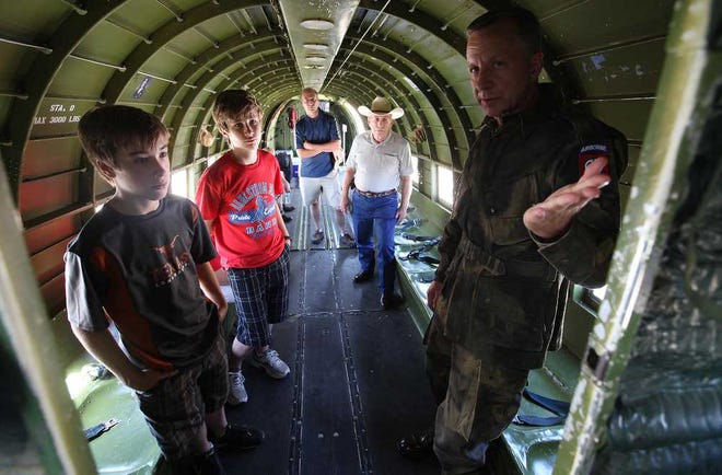 Rodney Roycroft with the WWII Airborne Demonstration Team give a tour of a Douglas C-47 to Andrew Weaver and Cole Ritchie at the Silent Wings Museum. The team was formed to honor and serve the memory of soldiers that fought and died in WWII. (Zach Long)