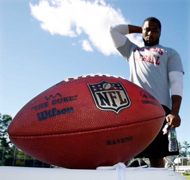 New York Jets defensive end Jamaal Westerman looks at a football during an informal workout on Thursday in Morris County, N.J. The NFL lockout means uncertainty not only for fans, players and owners, but for sponsors, too.