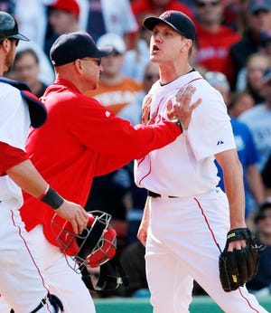Boston manager Terry Francona (center) restrains pitcher Jonathan Papelbon (right) in the ninth inning of yesterday's 9-8 win against Oakland.
