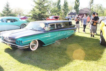 Spectators admire one of the many classic cars at Roosevelt Park in Devils Lake during the annual Devils Run.