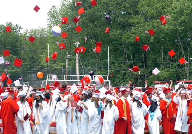 The Class of 2011 at Milford High School, throws their caps after receiving diplomas on Sunday.