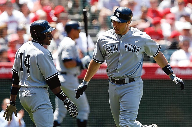 AP Photo/Chris Carlson 
New York Yankees first baseman Mark Teixeira, right, celebrates his two-run home run with Curtis Granderson against the Los Angeles Angels during the fifth inning in Anaheim, Calif., Sunday.